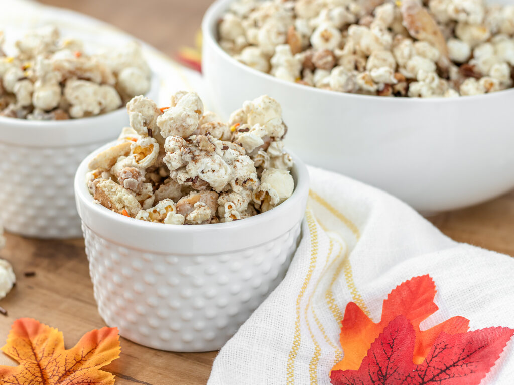 Close up of a bowl of Fall Harvest Popcorn with two other bowls full in the back.