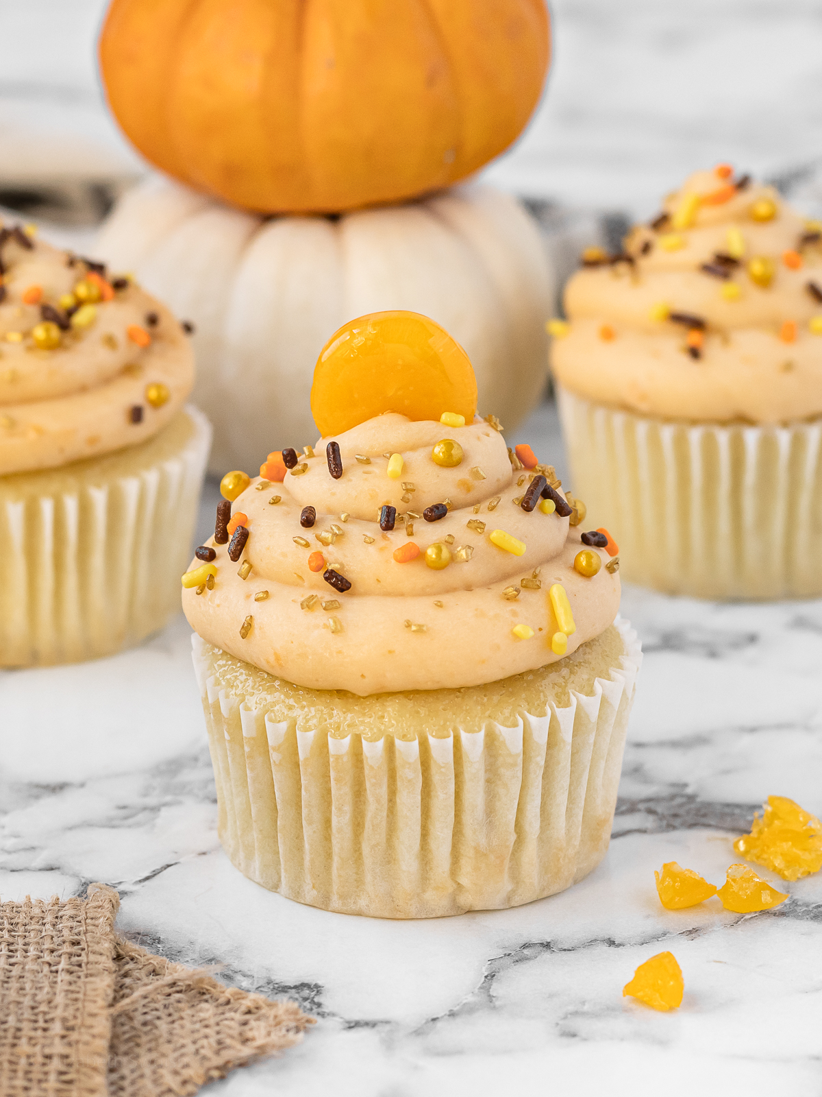 Cupcakes topped with butterscotch buttercream, festive fall sprinkles, and a butterscotch candy.