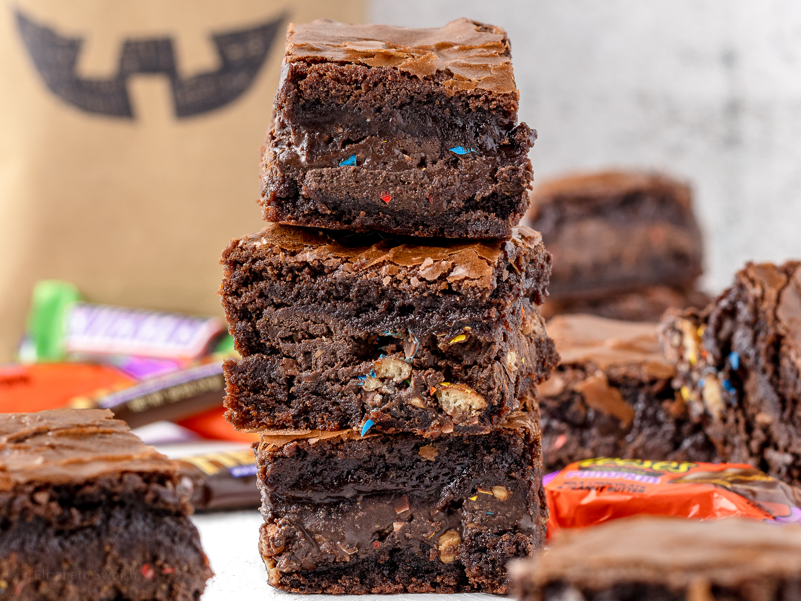 Stack of Halloween Candy Brownies with a close up of the melted leftover candy layer.