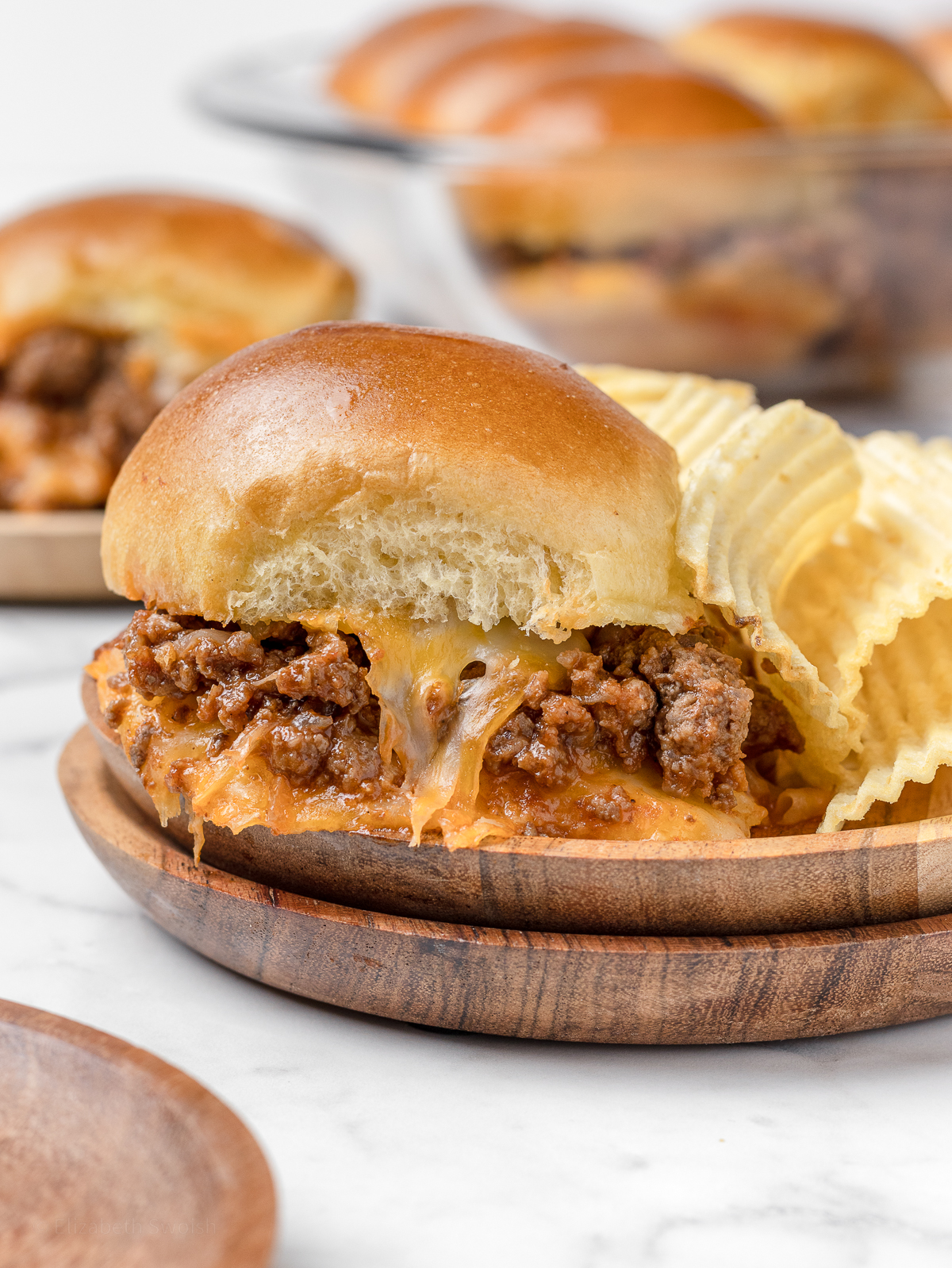 Sloppy Joe Slider on a plate with a side of chips.