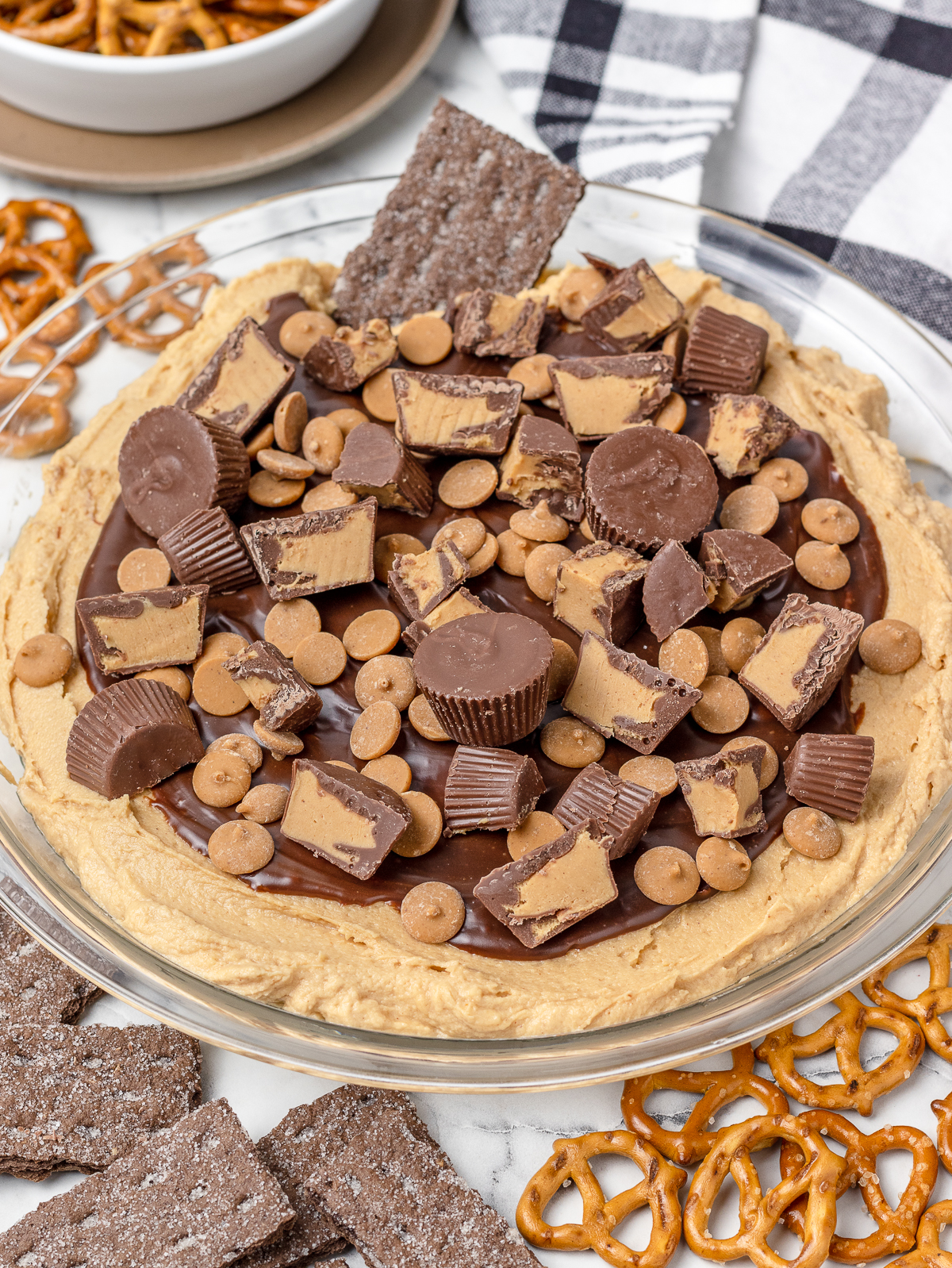 Pie plate filled with Chocolate Peanut Butter Pie Dip and tons of dippers on the side for dipping.