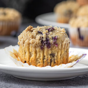 An unwrapped Blueberry Earl Grey Muffin topped with streusel.