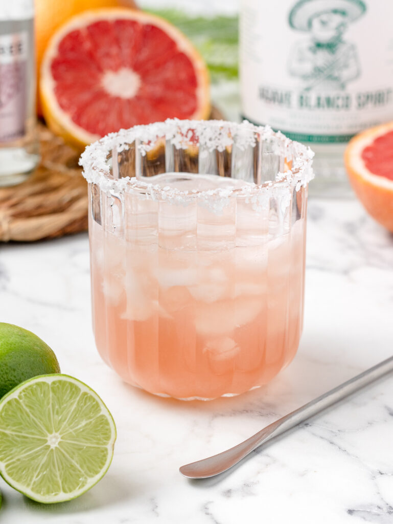 Step 2. To a glass add non alcoholic tequila, lime juice, light agave syrup, and ice.
