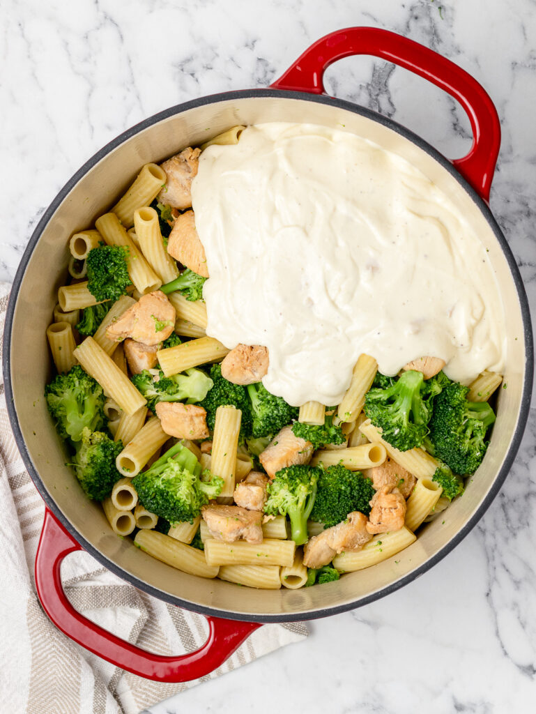 Step 3. The cooked chicken, broccoli, and pasta in a large pot. Topped with the sauce mixture.