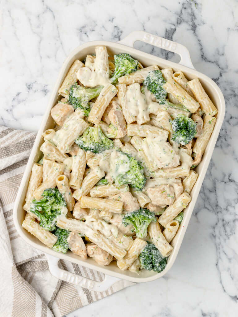 Step 5. The sauced chicken, broccoli, and pasta in a baking dish.