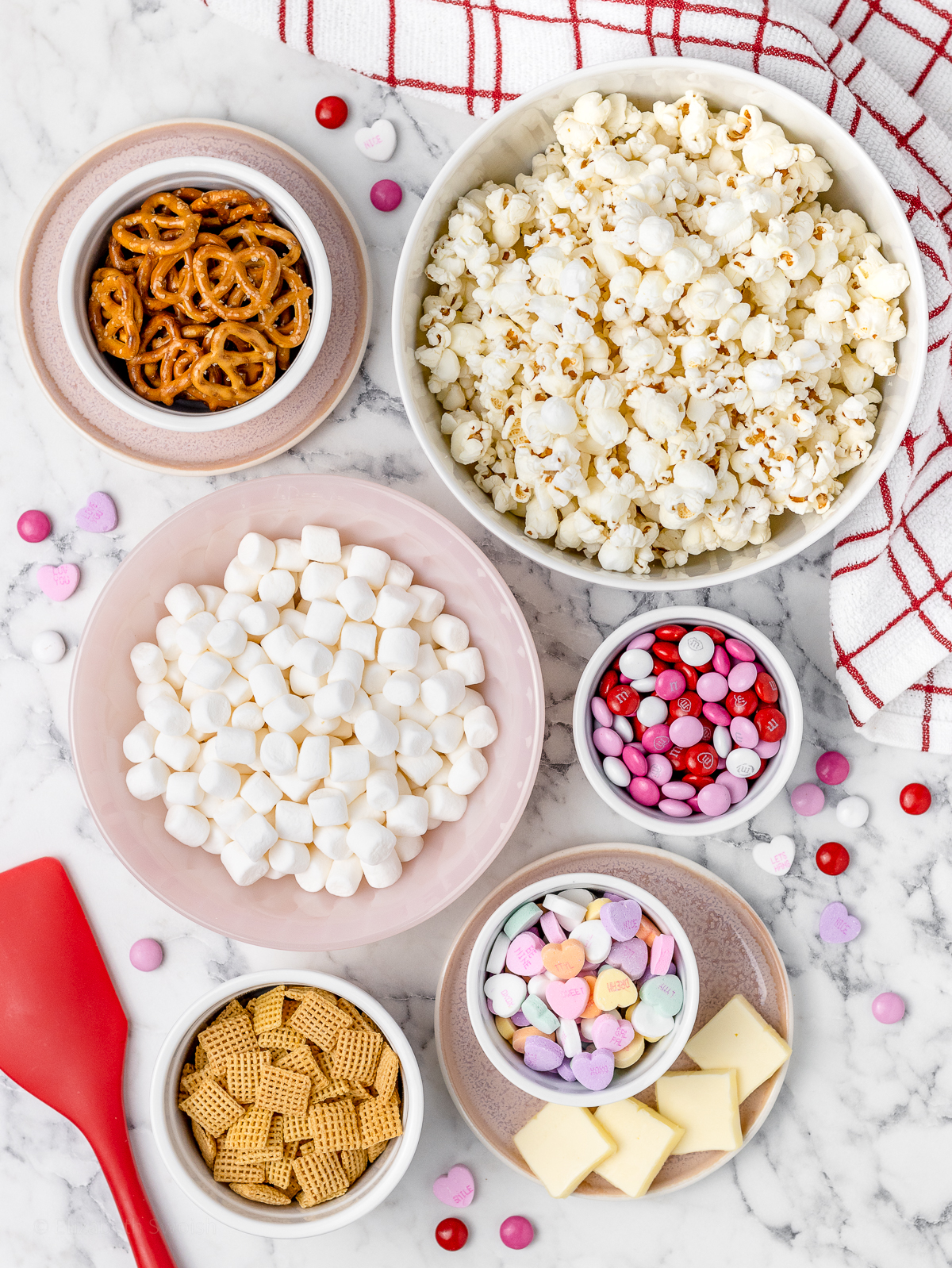 Ingredients. Plain popcorn, corn chex, mini pretzels, mini marshmallows, unsalted butter, mini M&Ms, and conversation hearts.
