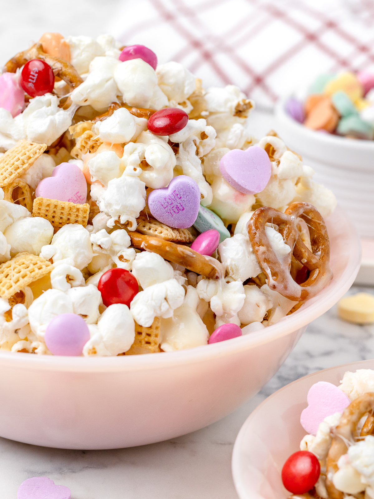 A bowl filled with marshmallow coated Valentines Day Popcorn.