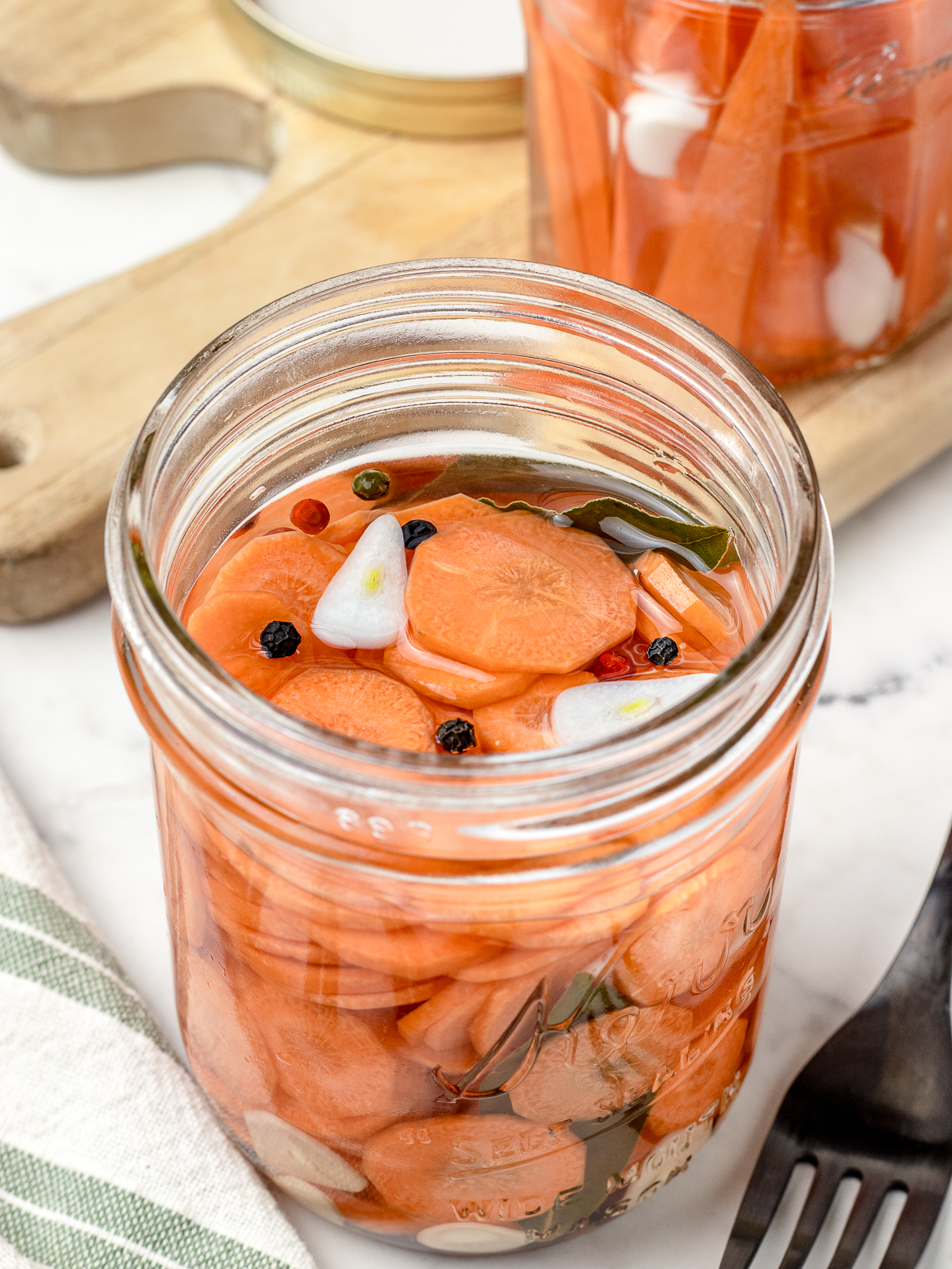 Jar of quick pickled carrots with fork on the side for eating.