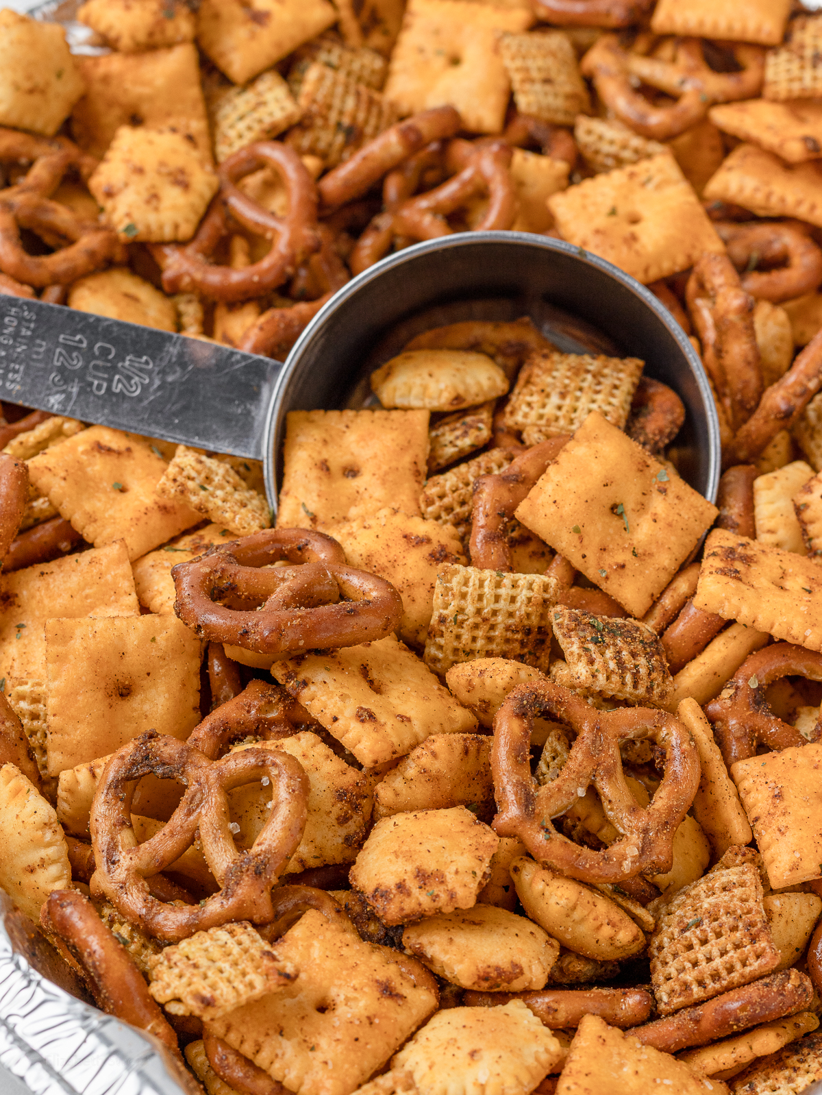 Snack mix with a scoop for scooping and eating.
