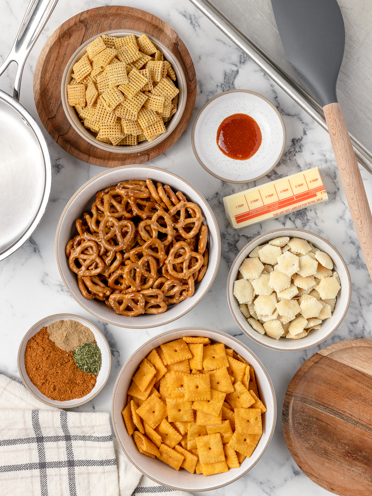 Ingredients you will need. Unsalted butter, taco seasoning, sriracha sauce, cumin, dried parsley, mini pretzels, corn chex, cheddar cheez its, and oyster crackers.