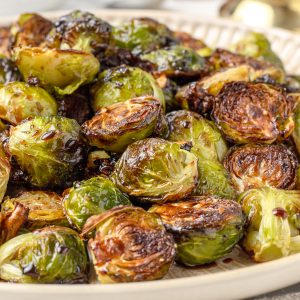 Close up of the Balsamic Honey Brussels Sprouts to see their crispy, caramelized edges, and the light coating of balsamic honey glaze.