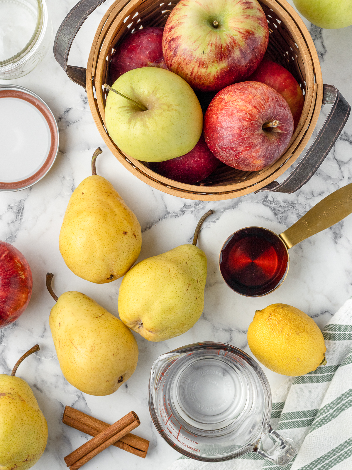 Ingredients needed. Fresh pears, fresh apples, water, maple syrup, lemon juice, and cinnamon stick.