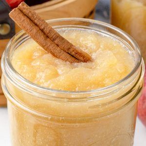 Close up of the cinnamon applesauce to see chunky smooth texture and the cinnamon stick in it.