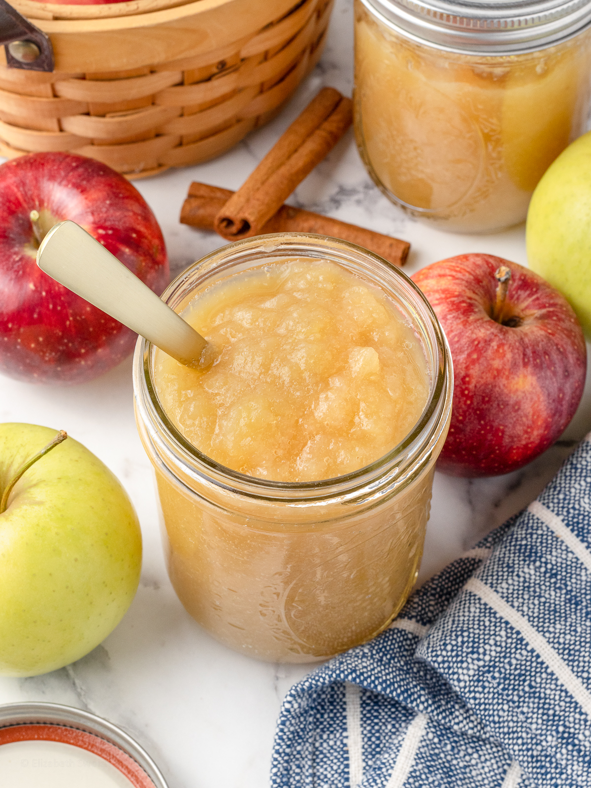 Spoon in the jar of chunky, smooth applesauce.