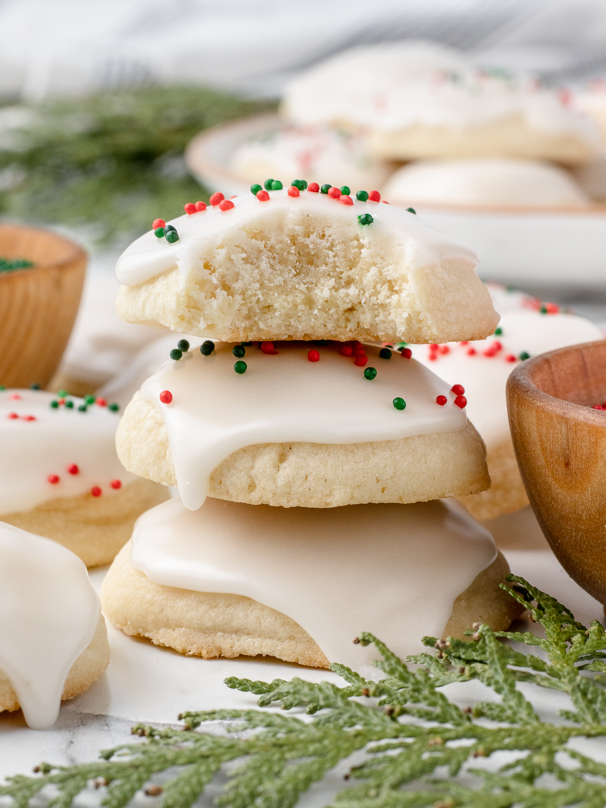 Stack of 3 cookies, the top one has a bite taken from it.