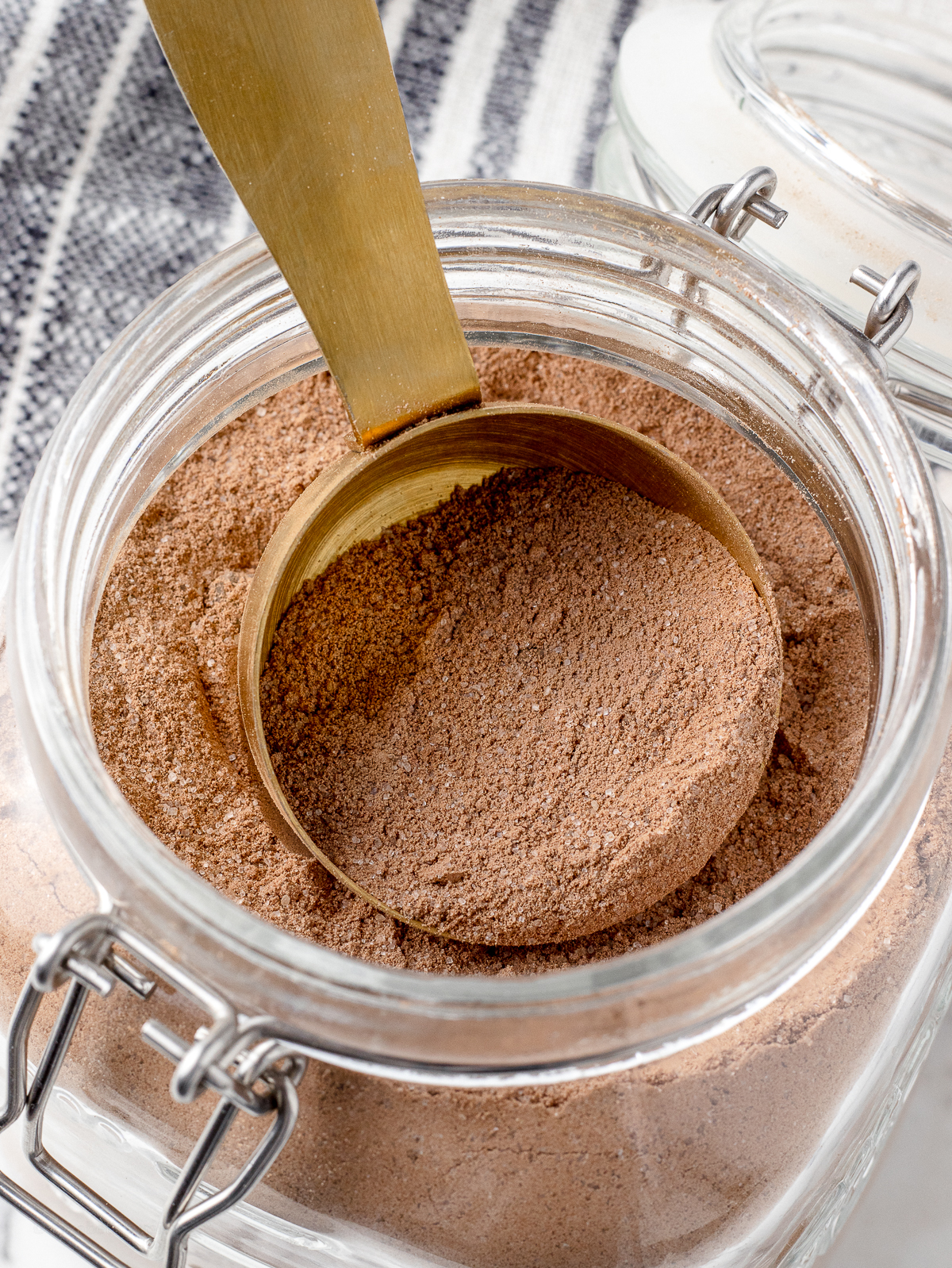 Jar of Hot Chocolate Mix with a scoop in it.