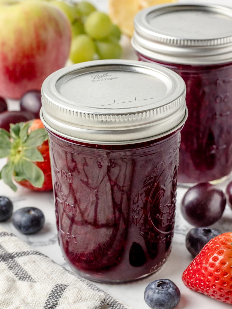 2 Jars of jam. One is ready to go in the refrigerator, the other in the freezer.