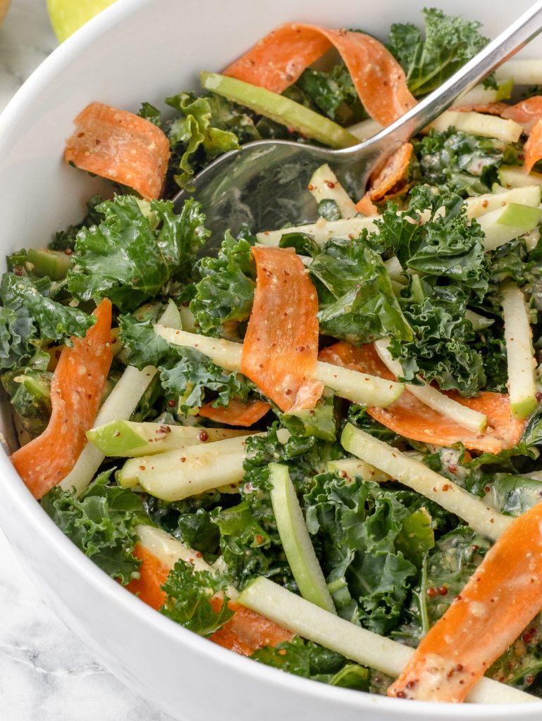 Slaw with crunchy kale, green apple matchsticks, with ribbons of carrots and a honey mustard dressing.
