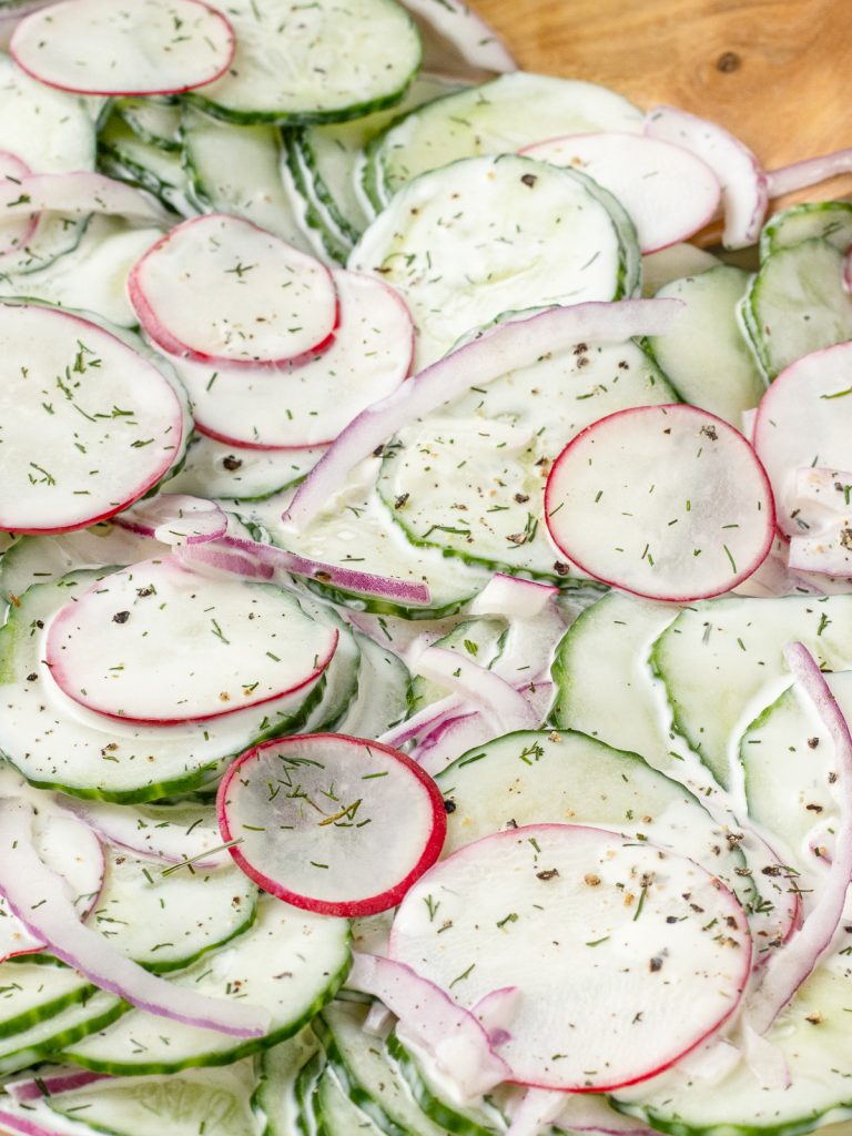 Close up of the salad to see the creamy crunchy textures and fresh dill, black pepper topping.