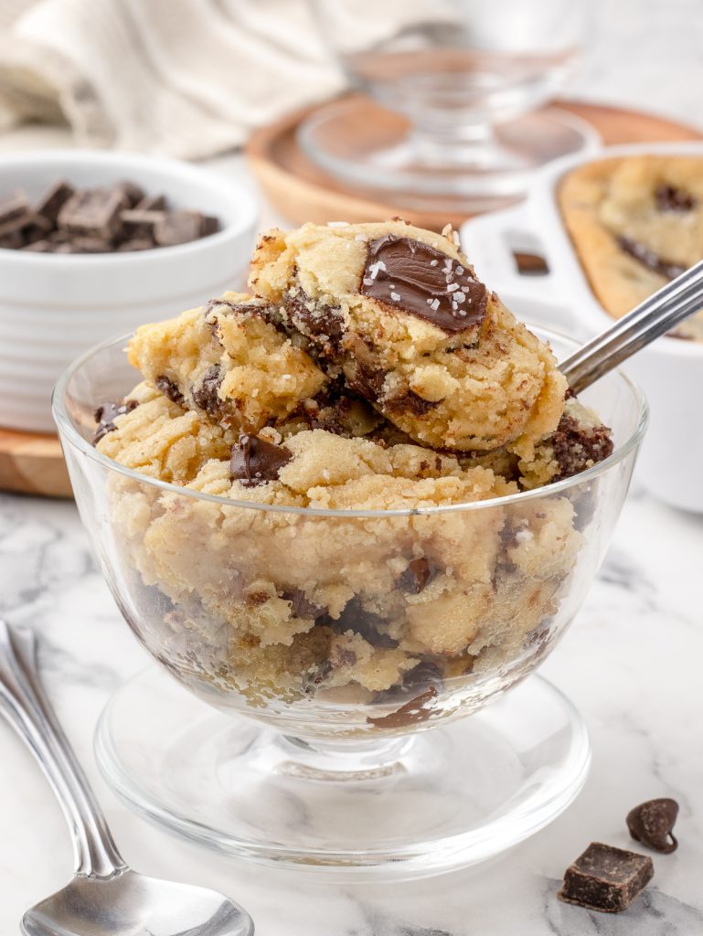 Dish of Scoopable Cookies. You can see the gooeyness, melty chocolate chips and chocolate chunks with flaky sea salt on top.