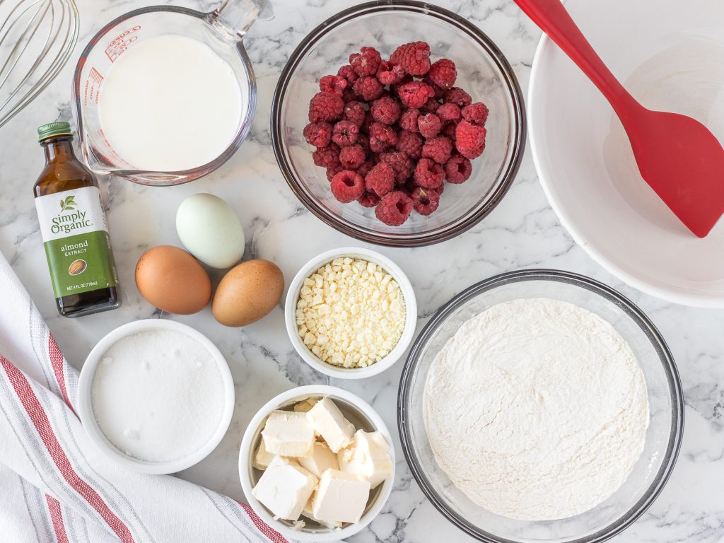 Ingredients needed. Fresh raspberries, flour, baking powder, salt, butter, sugar, eggs, buttermilk, almond extract, and white chocolate.